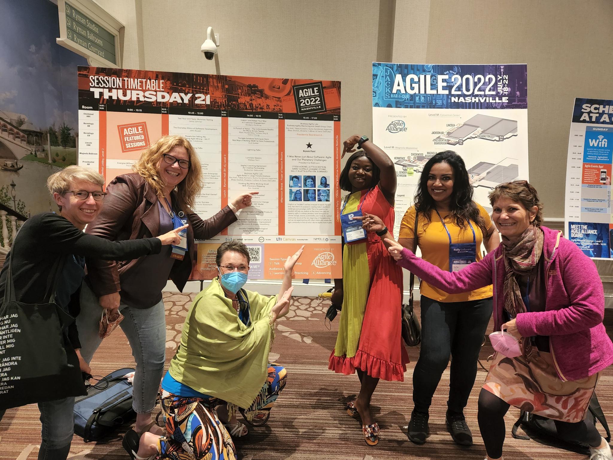 Agile 2022 Panelists pointing at their keynote slot
